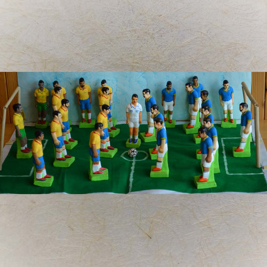 Handcrafted football match figurine set with vibrant player figures, a referee, goalposts, and a detailed field layout.