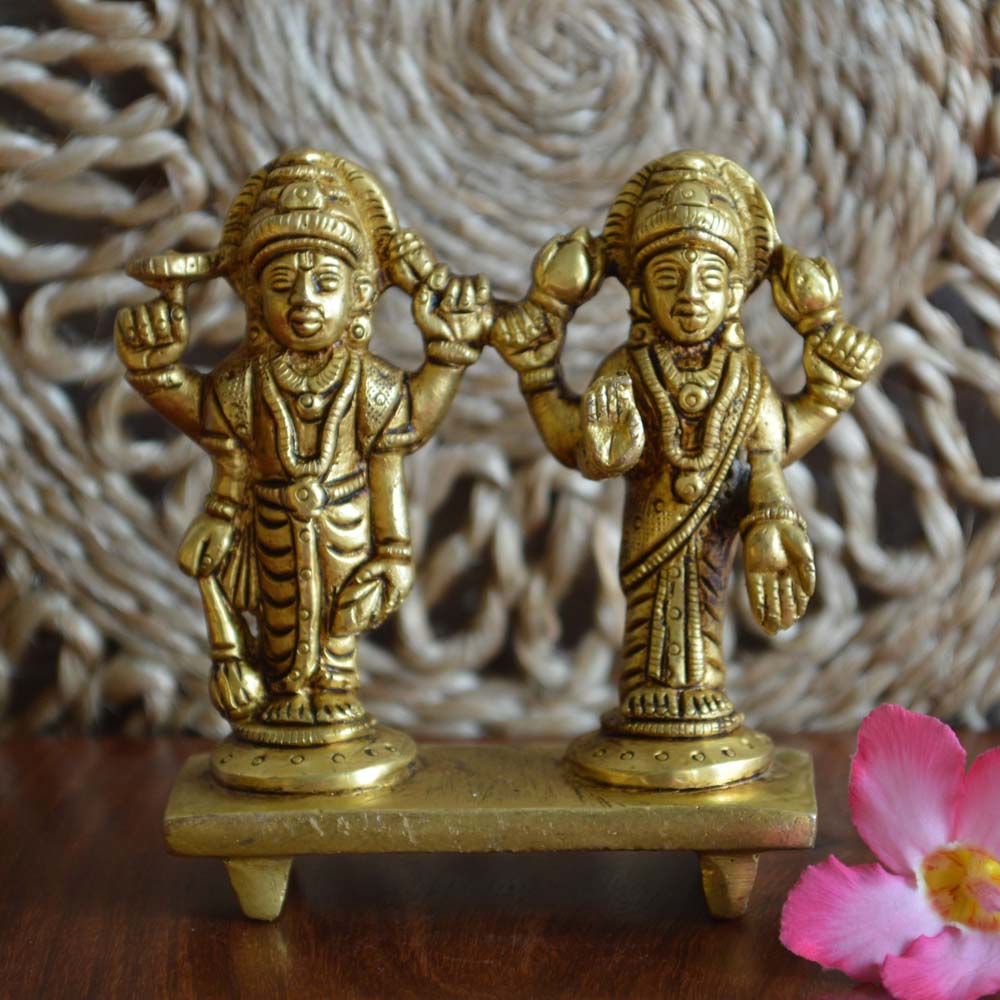 Eternal Vishnu and Lakshmi Idol Set in antique brass finish, intricately detailed and placed on a pedestal.