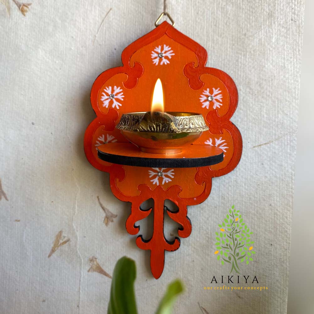Orange Wooden Wall Bracket with white floral motifs, ideal for holding oil lamps or decorative accents.