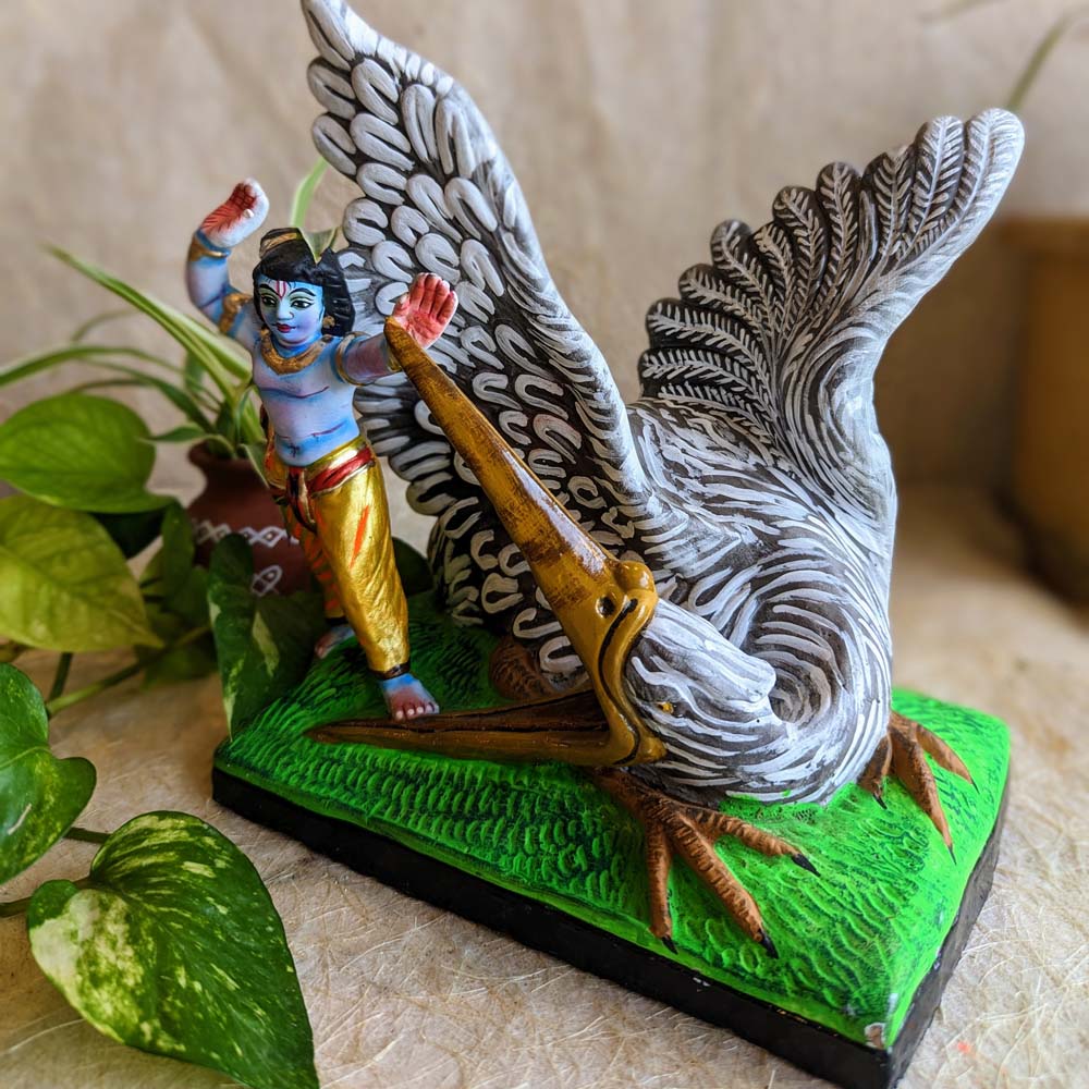 Handcrafted Navarathri Golu Doll depicting Krishna defeating Bakasura with vibrant detailing and traditional art.