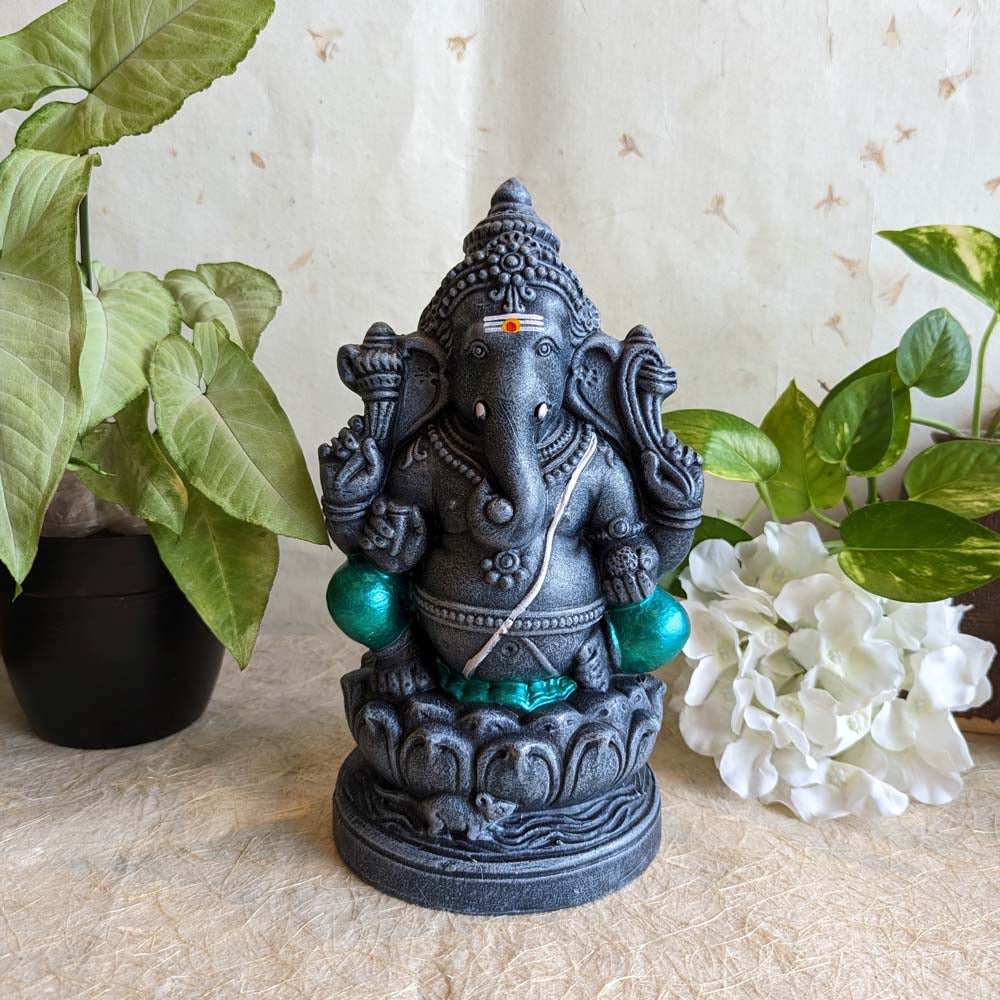 Stone-finish 12-inch Ganesh Golu doll in a seated posture with intricate details and green accents, perfect for Navarathri decoration.