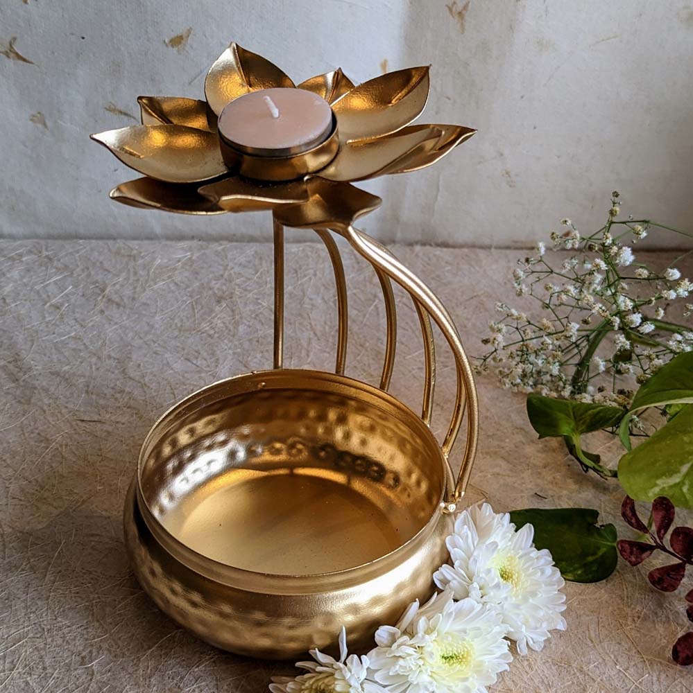 Handcrafted lotus tealight candle holder with a decorative hammered bowl in golden finish, adorned with flowers.