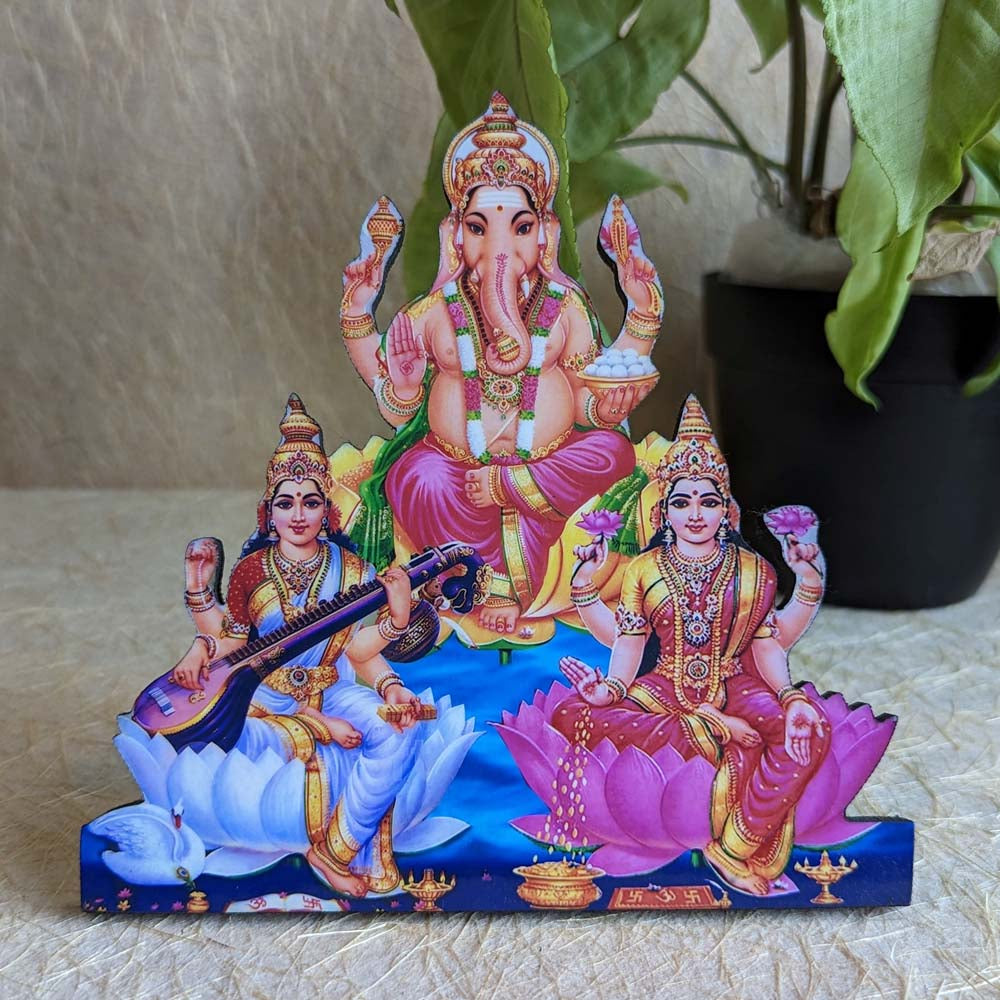 Decorative stand featuring Lord Ganesha, Goddess Lakshmi, and Goddess Saraswati seated on lotuses, ideal for pooja rooms and spiritual spaces.