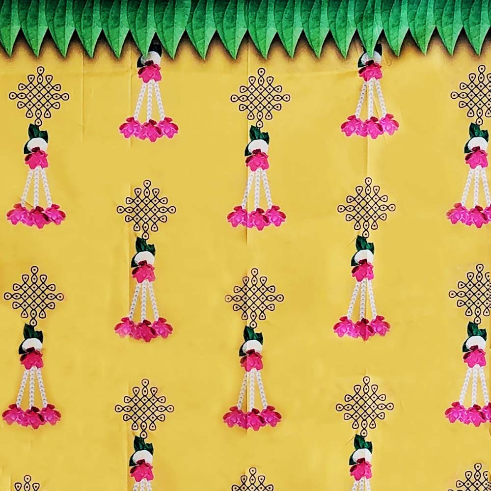 Festive yellow backdrop screen with green leaf toran, pink flower hangings, and intricate Kollam designs, ideal for traditional decor.