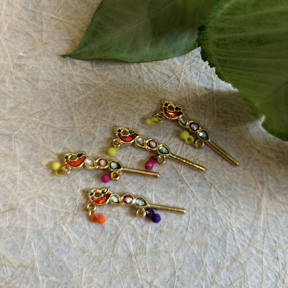 Enamelled Krishna flute with multicolor decorations and beads.