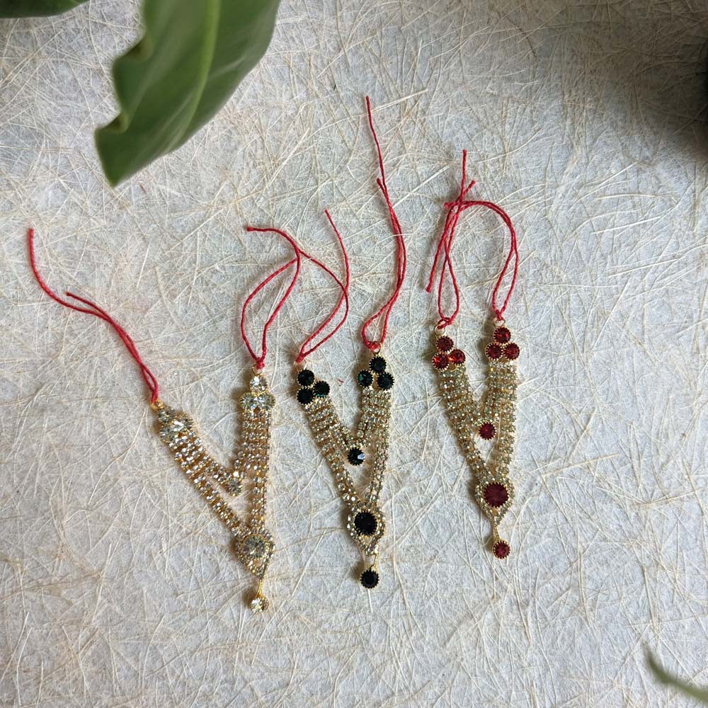 Set of four miniature deity necklaces with intricate designs, sparkling stones, and vibrant colored beads, tied with red threads.