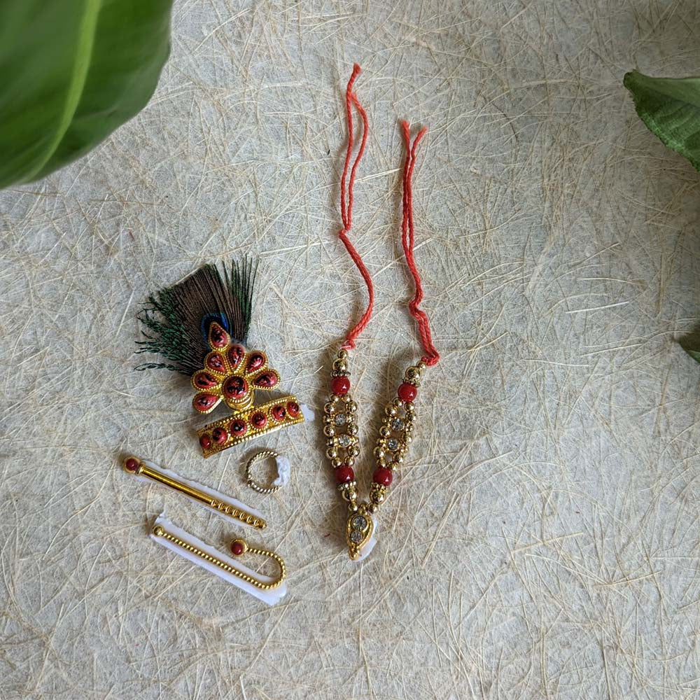 Traditional Krishna ornament set with a peacock feather mukut, necklaces, bangles, earrings, and accessories.