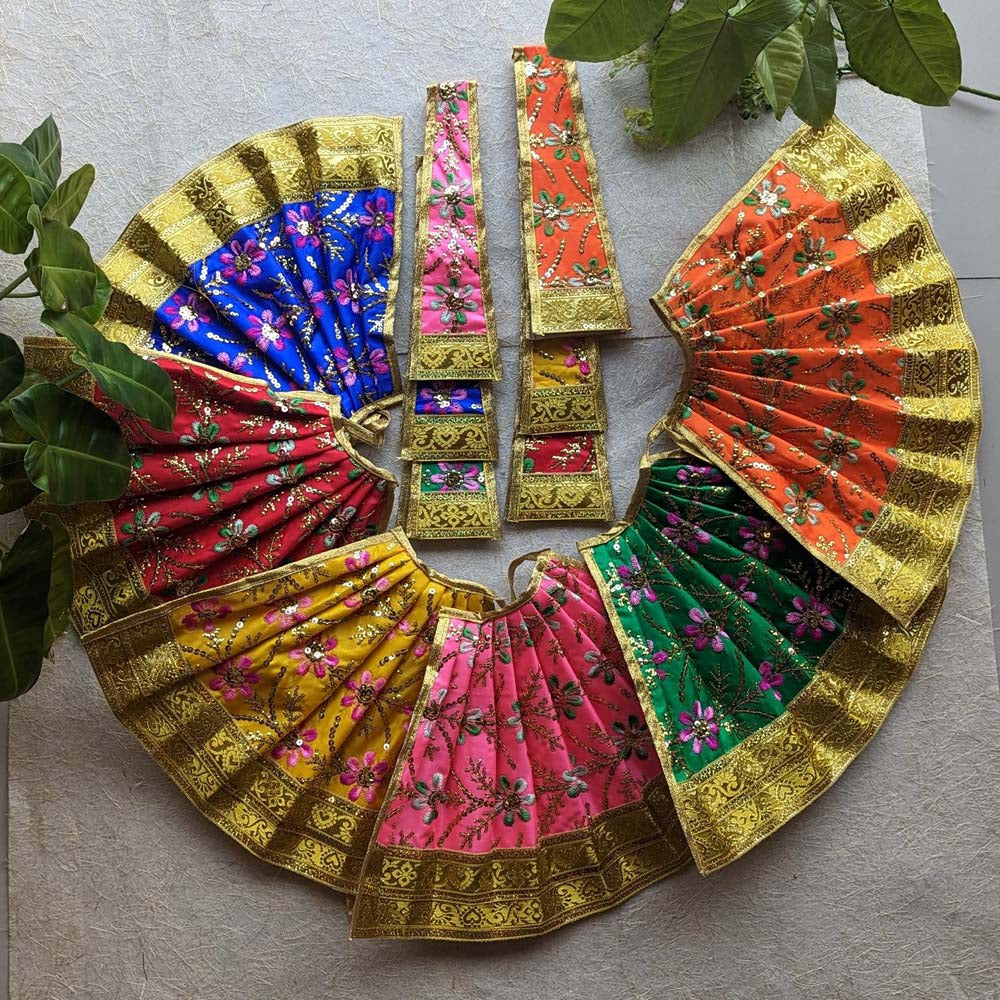 A collection of checked Devi skirts with golden borders in vibrant colors, perfect for decorating deity idols and ceremonial decorations.