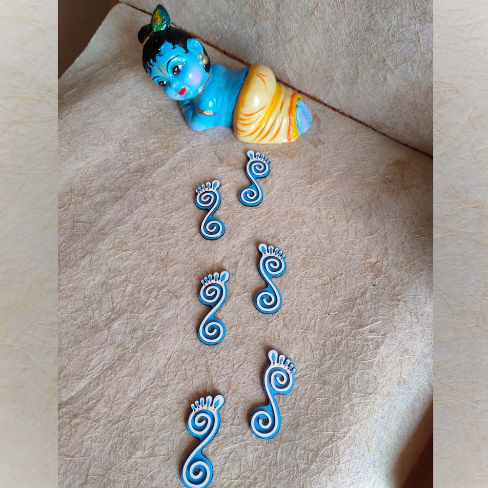 Krishna Paadham divine footprint stickers in a Set Of 2, featuring blue and white spiral designs with intricate detailing.