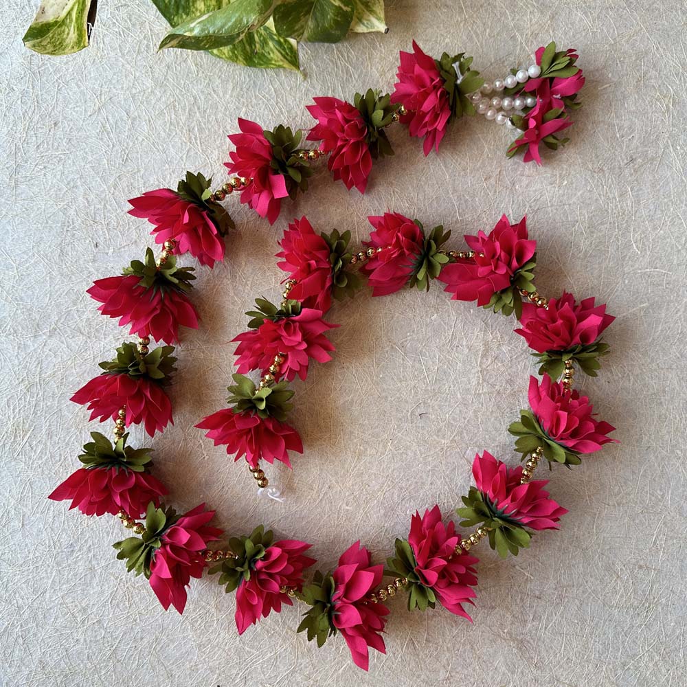 Red artificial floral garland with green leaves and gold bead accents, perfect for weddings, pooja, and festive decor.