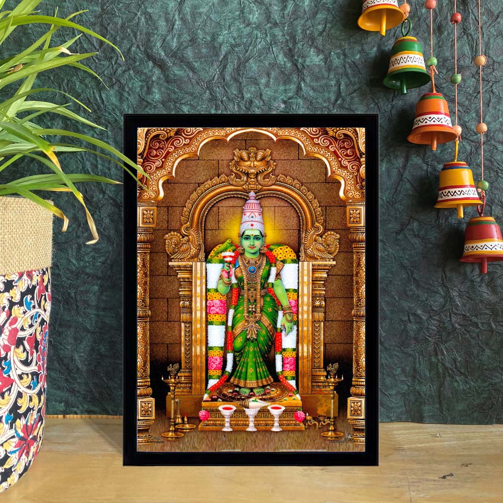 Meenakshi Amman framed artwork featuring the Goddess in a vibrant green saree, adorned with jewelry, seated within an ornate golden temple arch.
