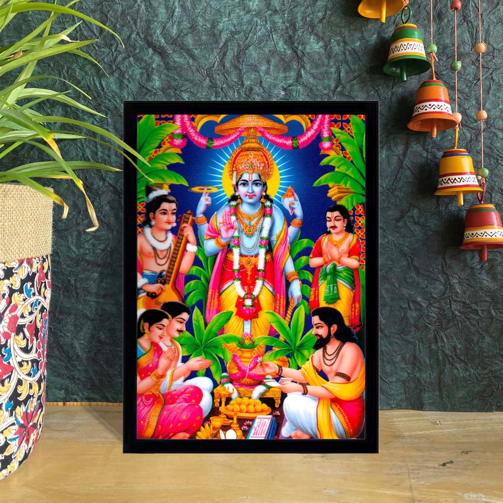 Framed artwork of Lord Sathyanarayana Swamy Vishnu with devotees, surrounded by vibrant greenery and traditional detailing.