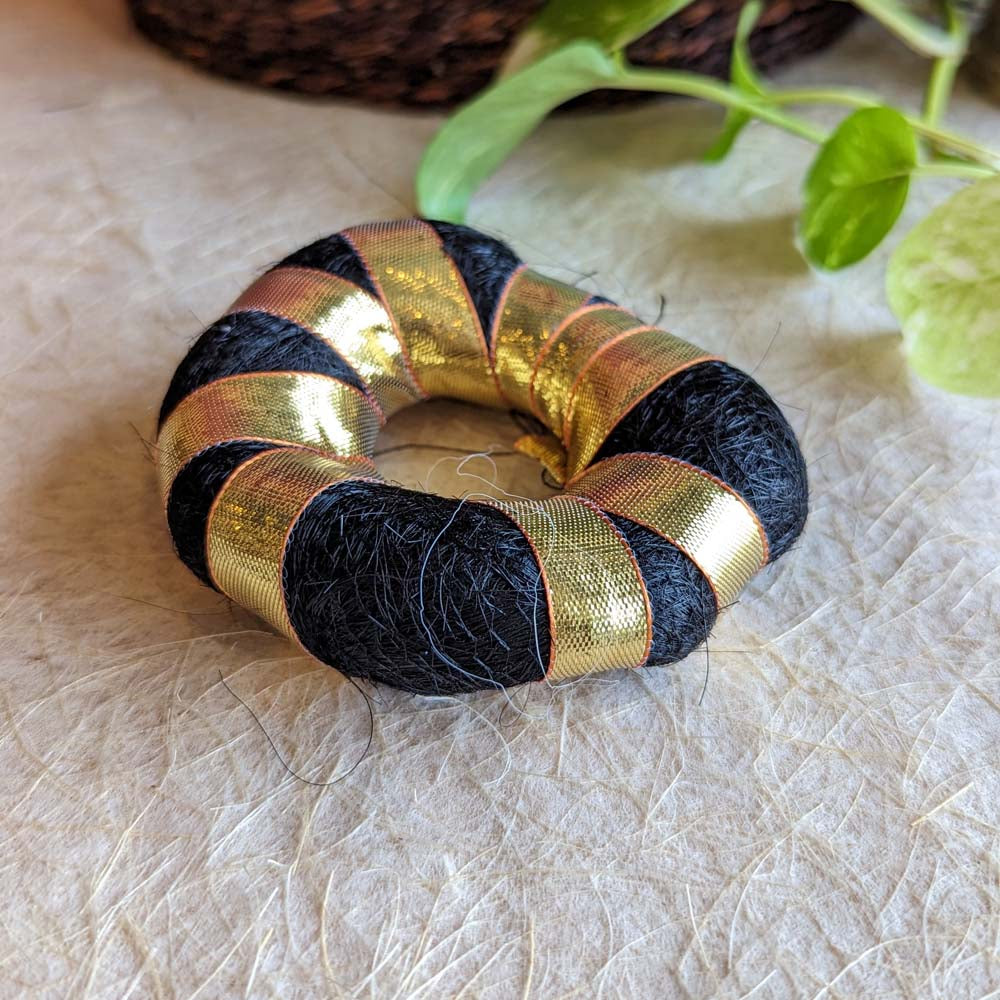 Soft black hair bun ring with golden ribbon detailing for traditional and cultural hairstyles