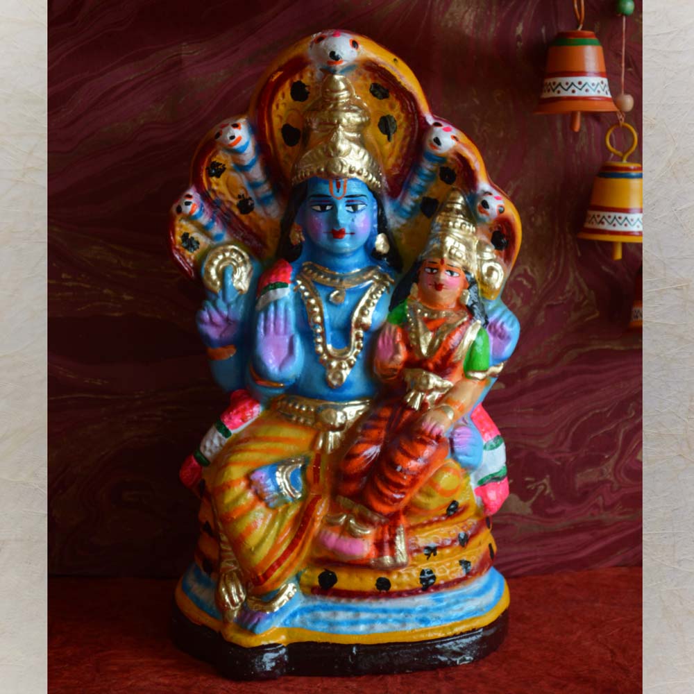 Handcrafted Navaratri Golu doll of Lord Narayana with Sridevi and Bhudevi, seated on Adisesha, adorned with vibrant colors and intricate details.