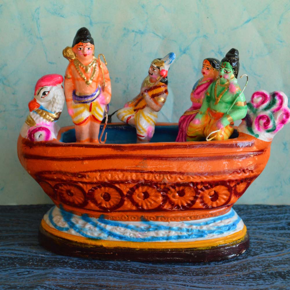 Handcrafted Ramayana Golu Dolls depicting Ram, Sita, Lakshmana, and Guhan on a colorful traditional boat for Navarathri decor.