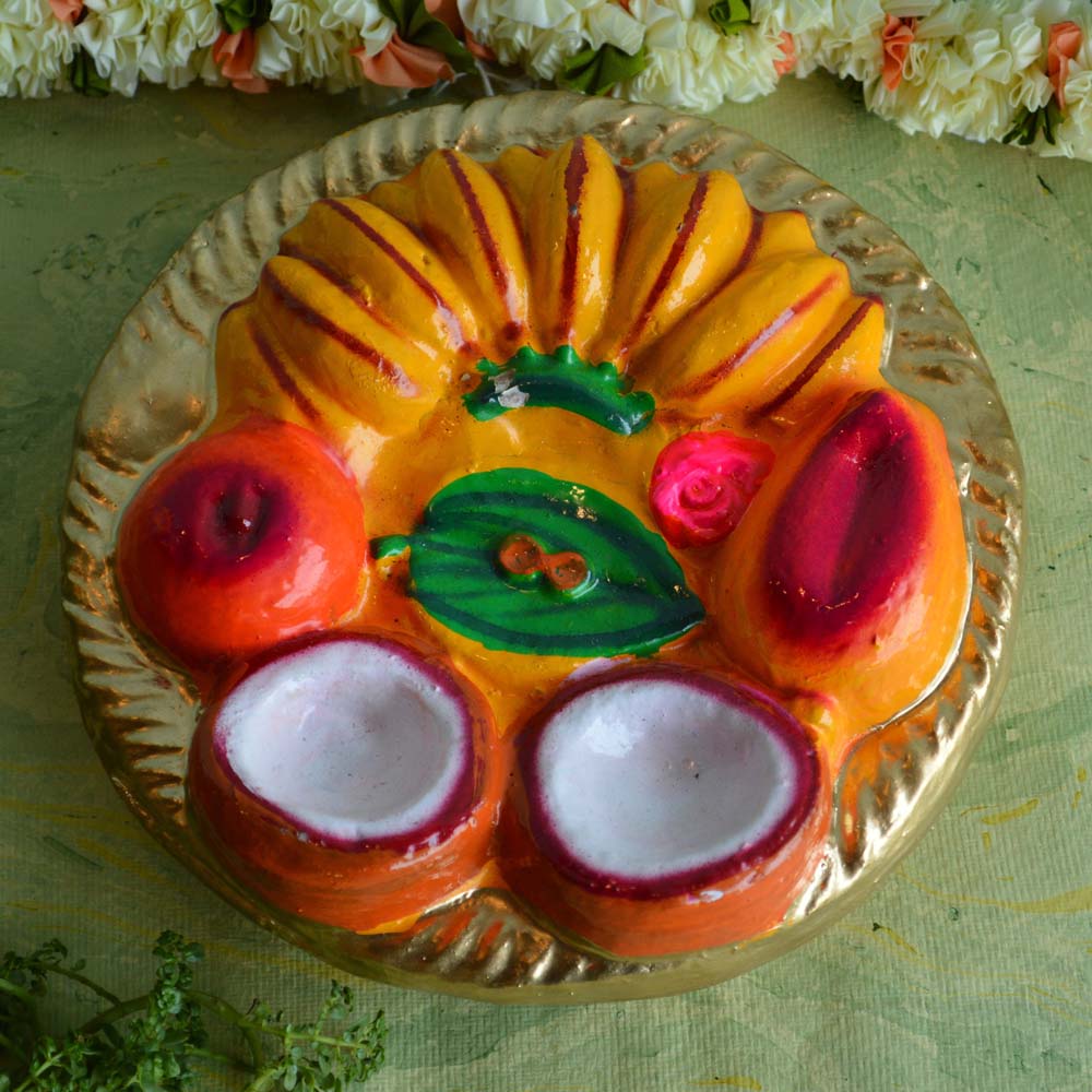 Hand-painted Thambulam Plate Golu doll with bananas, betel leaves, coconuts, and vibrant colors, ideal for Navarathri decorations.