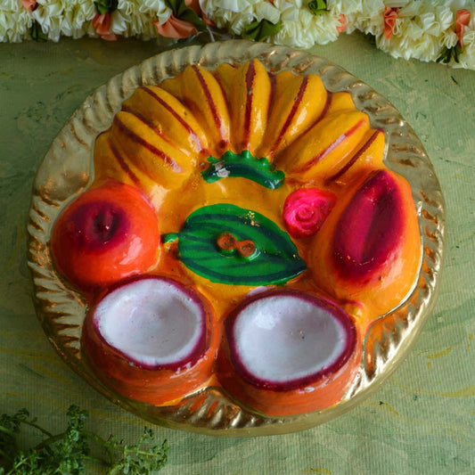 Hand-painted Thambulam Plate Golu doll with bananas, betel leaves, coconuts, and vibrant colors, ideal for Navarathri decorations.