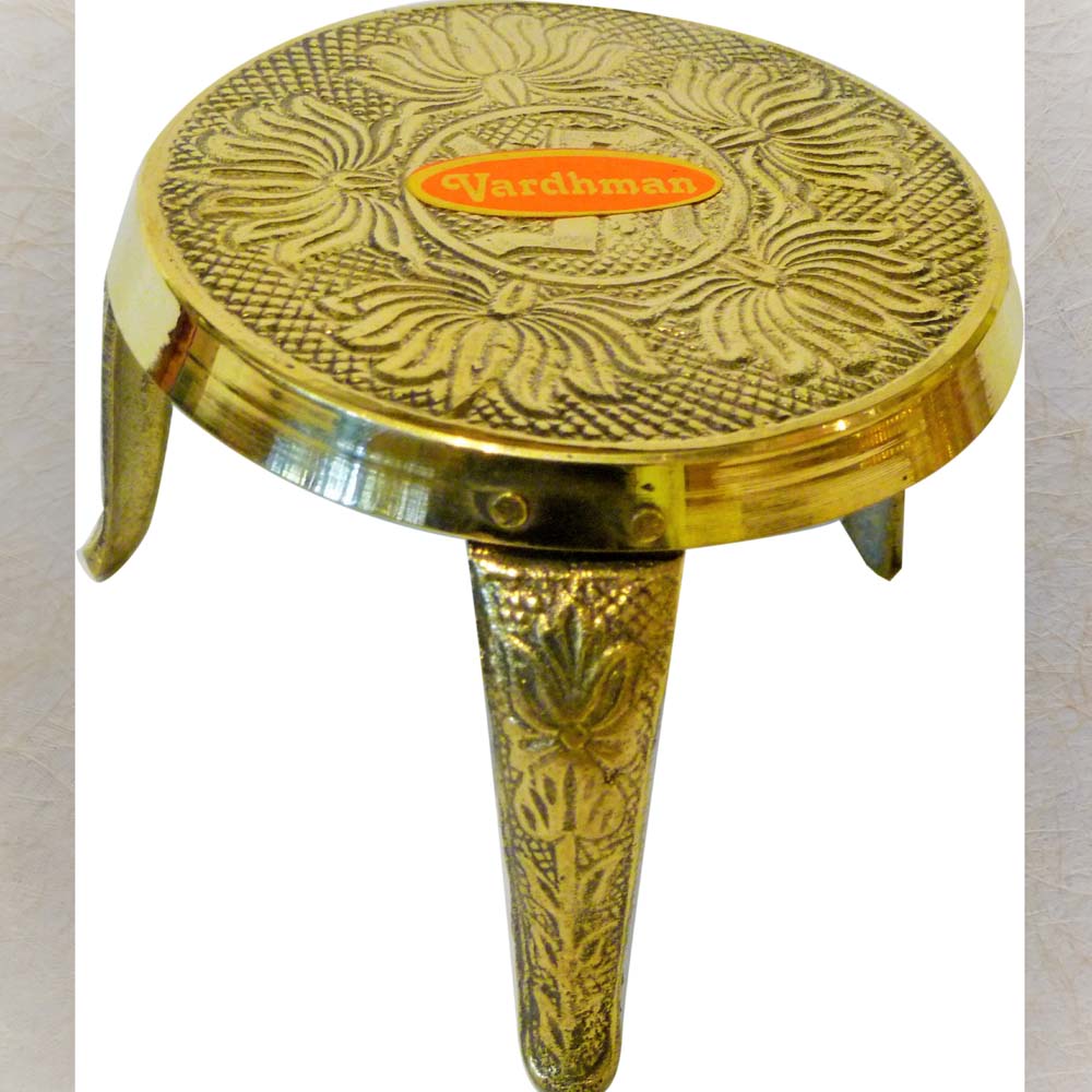 Brass decorative stand with floral design and Vardhman branding.