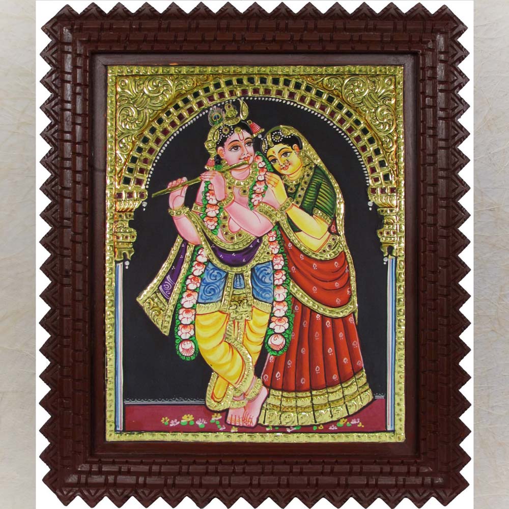 Tanjore painting of Radha Krishna with Lord Krishna playing the flute, surrounded by gold foil detailing and vibrant traditional colors.