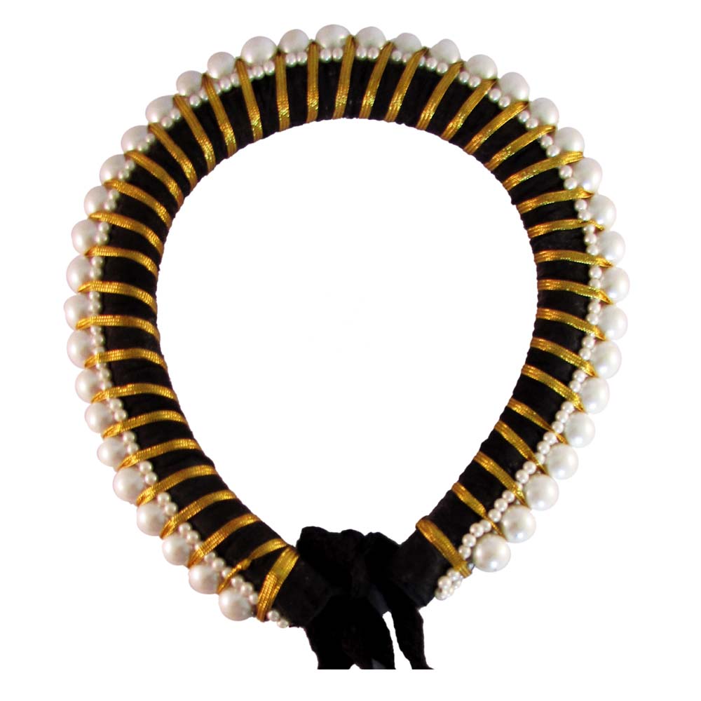 Handcrafted white Konda flower garland with green accents placed on a woven basket, perfect for hair decoration