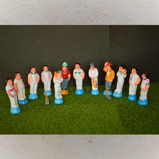 Handcrafted Golu Doll Cricket Set featuring cricket players, an umpire, and equipment, capturing the spirit of a lively cricket match.