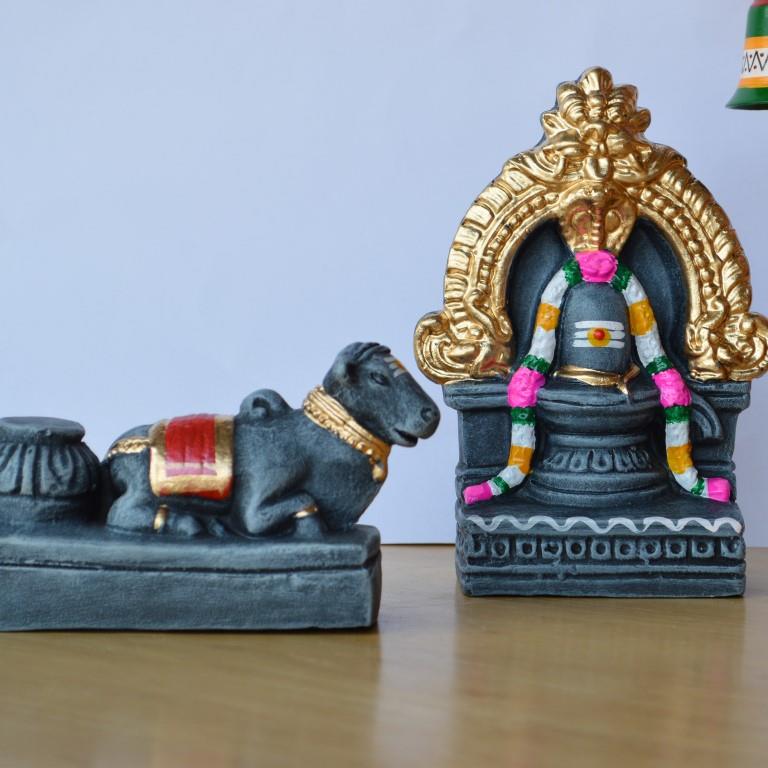 Handcrafted large Nandi and Shiva Lingam idol set with stone finish, gold and pink highlights, and intricate arch design for Navaratri Golu.