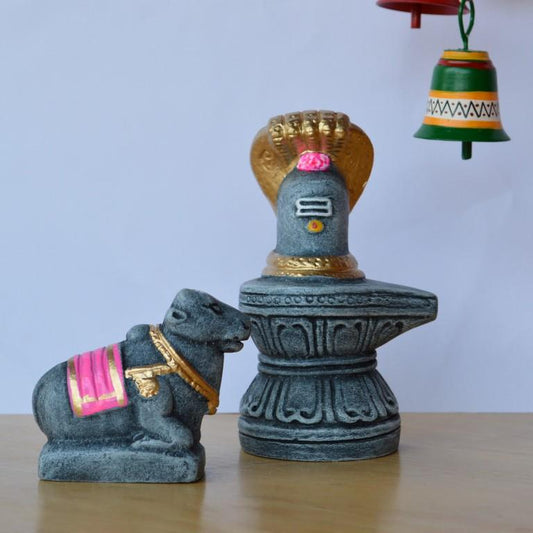 Handcrafted Nandi and Shiva Lingam idol set in stone finish with gold and pink accents, ideal for Navaratri Golu.