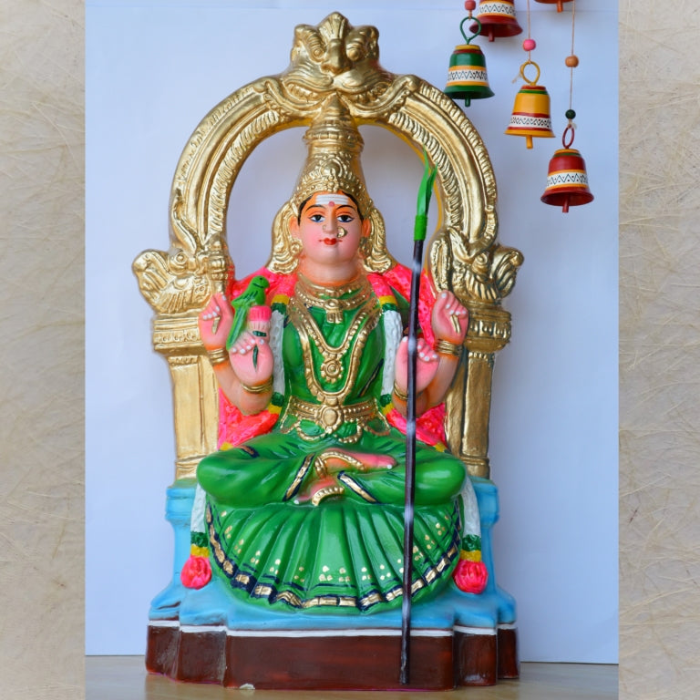 Handcrafted Kamakshi Amman Golu Doll in a green saree with a golden arch backdrop, ideal for Navaratri festive decor.