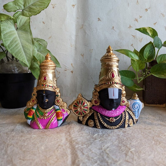Handcrafted Perumal and Thayar bust idols with black base, gold crowns, and vibrant ornaments for Navaratri Golu.