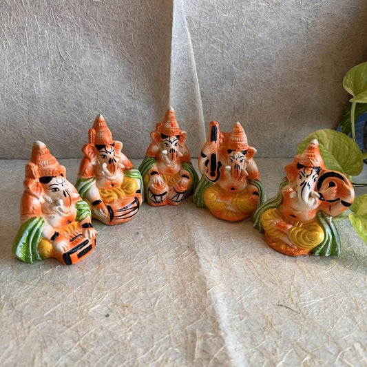 Handcrafted Navarathri Golu Ganesh Musical Ensemble with five miniature figures of Lord Ganesha playing Tabla, Veena, Mridangam, Harmonium, and Flute.