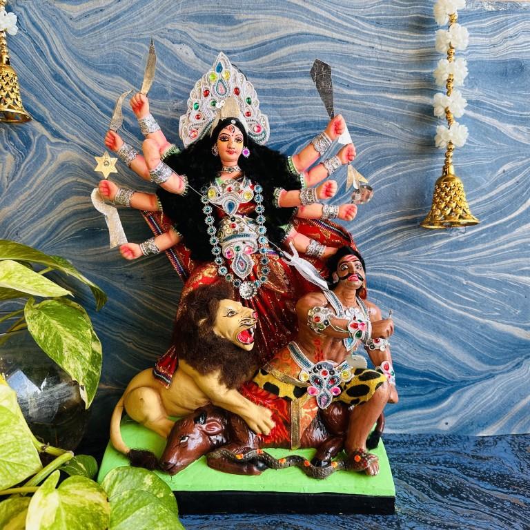 Large handcrafted Durga Golu doll with vibrant colors, jewel embellishments, and intricate details, featuring Durga slaying Mahishasura on a lion mount.