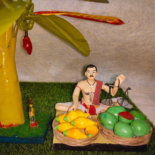 Handcrafted Vendor Fruit Seller doll set with a weighing scale, fruit baskets, and a banana tree, perfect for Navarathri Golu displays.