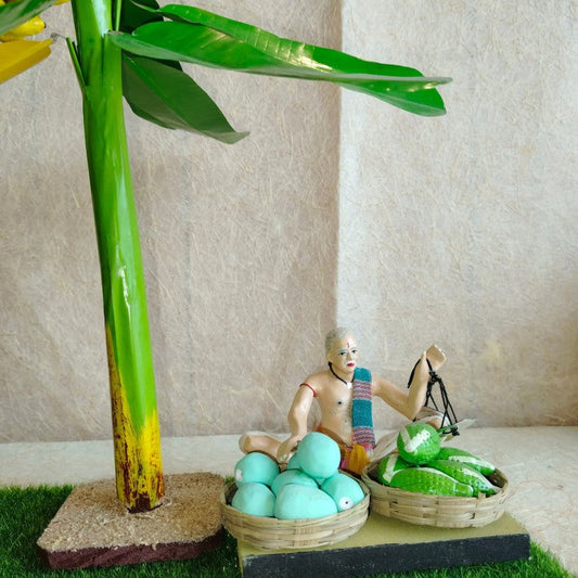 Handcrafted Vendor Fruit Seller doll set with green fruits, a weighing scale, and a banana tree for Navarathri Golu displays.
