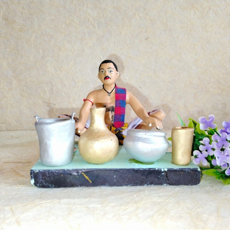 Handcrafted Navarathri Golu doll of a traditional Indian potter creating clay pots and utensils.