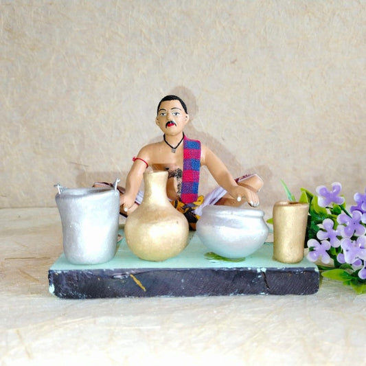 Handcrafted Navarathri Golu doll of a traditional Indian potter creating clay pots and utensils.