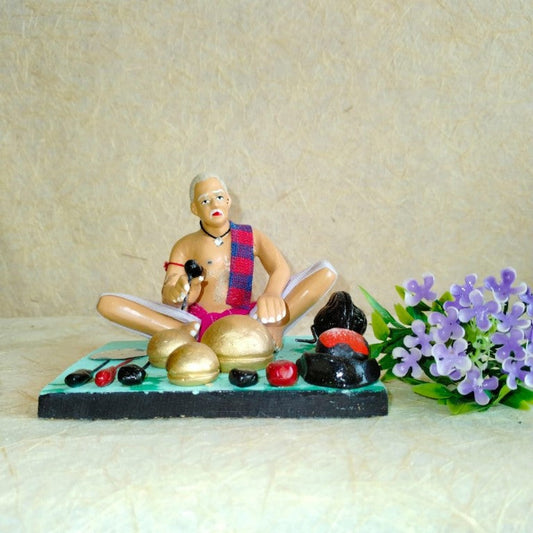 Handcrafted Navarathri Golu doll of a traditional Indian potter creating clay pots and utensils.