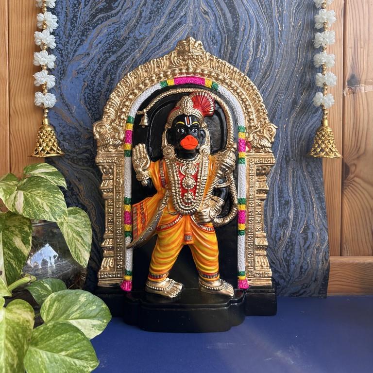 Navarathri Golu doll of Lord Hanuman in a vibrant standing posture adorned with a golden arch and intricate ornaments.