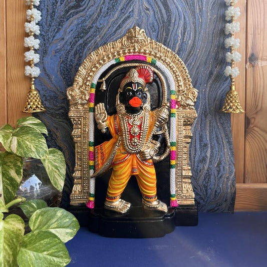 Navarathri Golu doll of Lord Hanuman in a vibrant standing posture adorned with a golden arch and intricate ornaments.