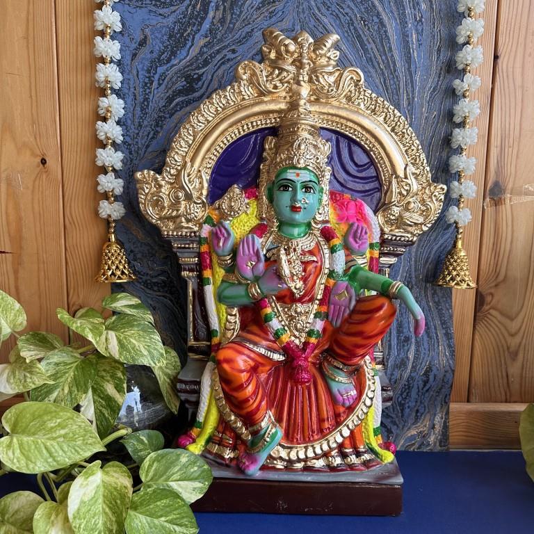 Handcrafted Navarathri Golu doll of Goddess Neelayadakshi in a red saree, seated on a golden throne with vibrant ornamentation.