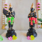 Handcrafted Navarathri Golu dolls depicting Black Hanuman and Garuda in vibrant traditional attire with gold embellishments.
