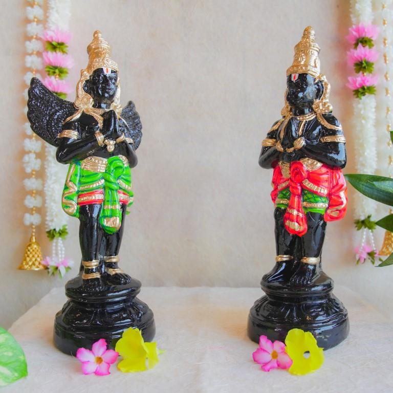 Handcrafted Navarathri Golu dolls depicting Black Hanuman and Garuda in vibrant traditional attire with gold embellishments.