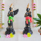 Handcrafted Navarathri Golu dolls depicting Black Hanuman and Garuda in vibrant traditional attire with gold embellishments.