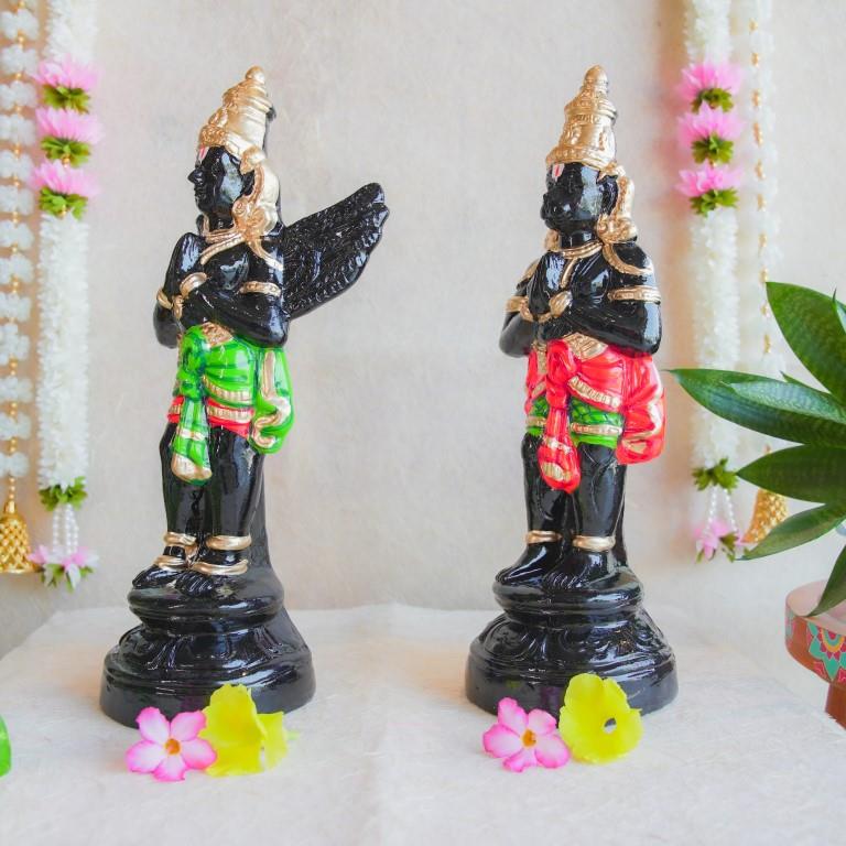 Handcrafted Navarathri Golu dolls depicting Black Hanuman and Garuda in vibrant traditional attire with gold embellishments.