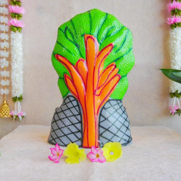 Handcrafted Navarathri Golu doll depicting Lord Dakshinamoorthy seated under a serpent canopy with vibrant detailing.