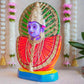 Handcrafted Navarathri Golu doll of Goddess Renugammal with a vibrant gold and green decorative backdrop.