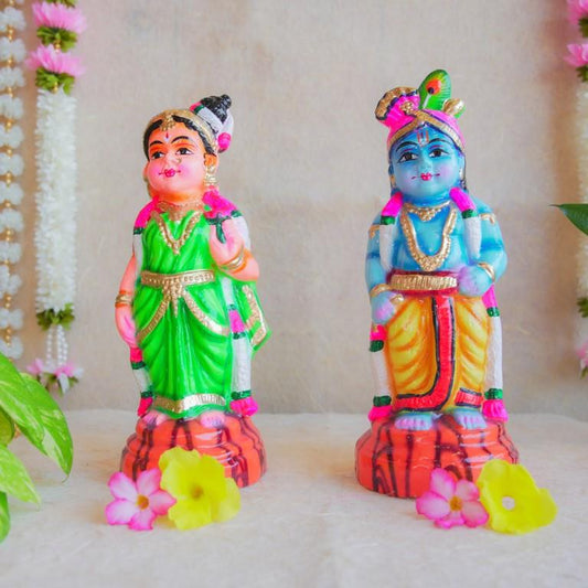 Handcrafted Navarathri Golu Dolls featuring Lord Krishna with a flute and Andal in traditional attire with vibrant colors.