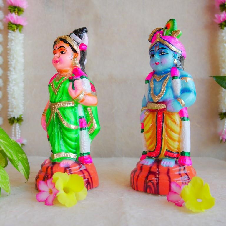 Handcrafted Navarathri Golu Dolls featuring Lord Krishna with a flute and Andal in traditional attire with vibrant colors.