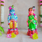 Handcrafted Navarathri Golu Dolls featuring Lord Krishna with a flute and Andal in traditional attire with vibrant colors.