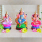 Handcrafted Navarathri Golu dolls of Durga, Lakshmi, and Saraswathi, beautifully painted and displayed with floral decorations.