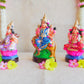 Handcrafted Navarathri Golu dolls of Durga, Lakshmi, and Saraswathi, beautifully painted and displayed with floral decorations.